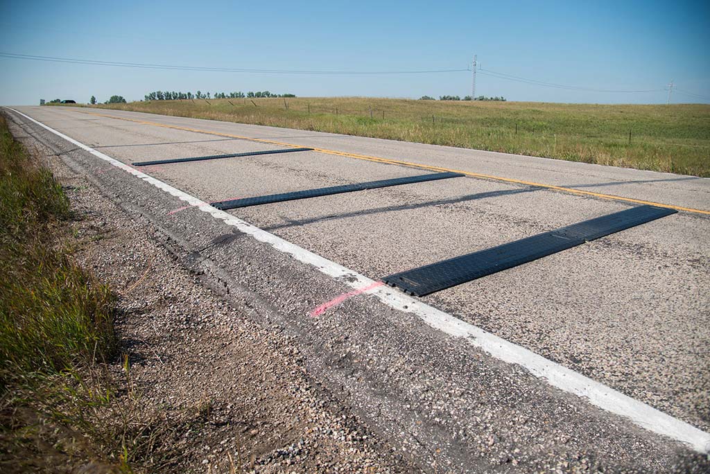 Black speed bumps on roads to reduce vehicle speed