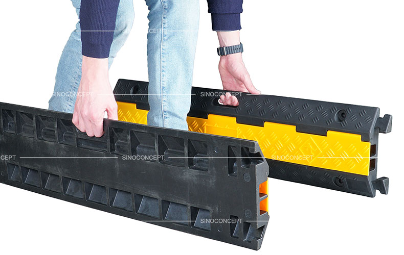 A two-channel rubber cable ramps also called two channels cable ramps designed with convenient handles for easy movement.