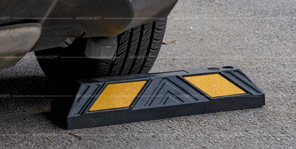 Wheel stop, also called wheel stopper, made of black recycled rubber used as car park safety equipment.