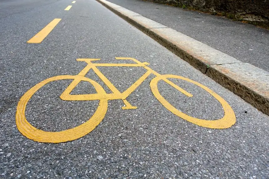 Yellow bike lane markings signal to drivers that the marked area is reserved for cyclists.