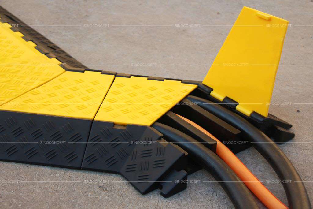 A 3-channel rubber cable ramp hides and protects electrical cords.