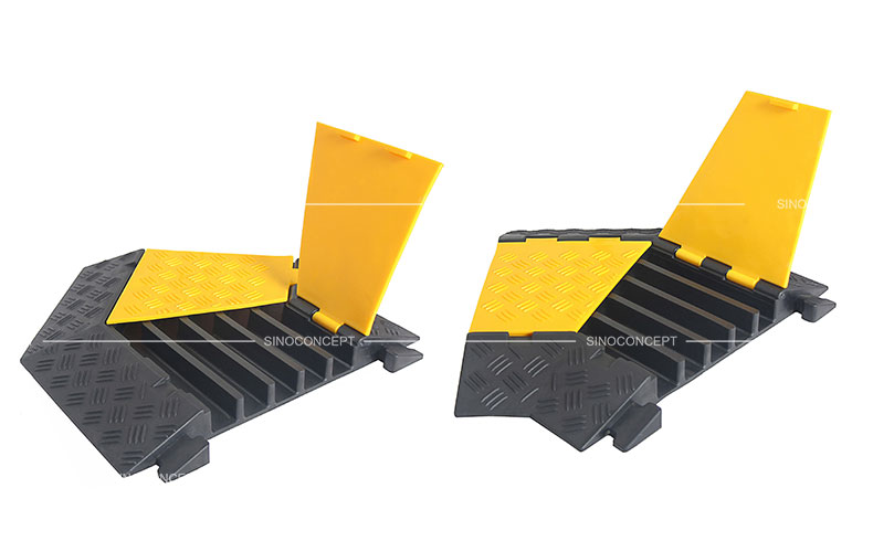 5-channel cable covers angle parts made of black recycled rubber and covered with yellow plastic lids to protect cables or hoses.