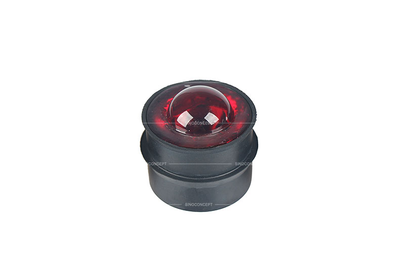 Red glass traffic road stud also called reflective road stud made of glass and steel used as a traffic safety device