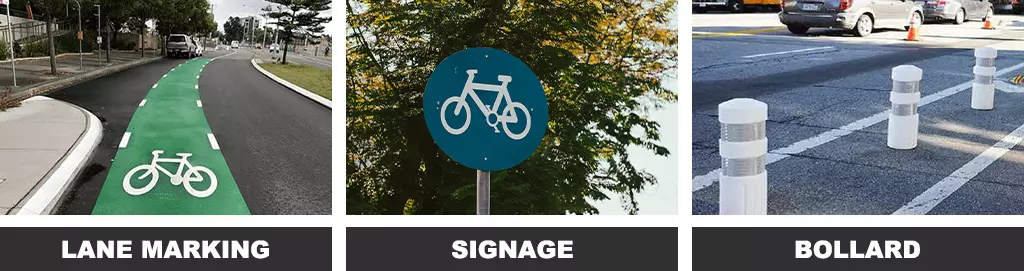 Green and white bike lane markings, a bike lane signage, and white cycle lane bollards on the road.