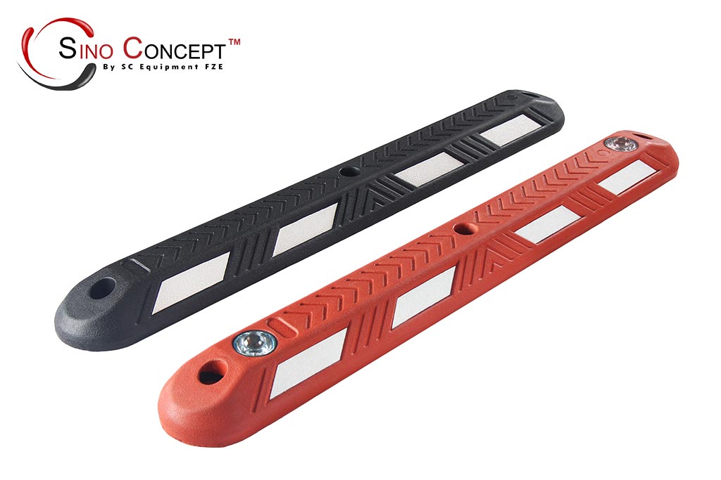 Black and red lane dividers made of recycled rubber with road studs embedded and white reflective films pasted