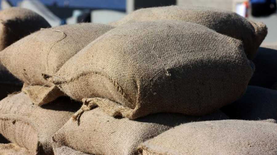 Many filled burlap sandbags put together.