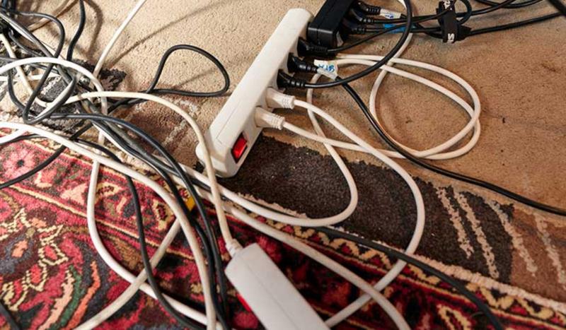 Messy wires on the carpet, which can cause cable-related dangers.