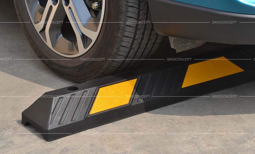 A parking block, also called a car parking stopper, is made of black recycled rubber and yellow reflective tapes for car park management.