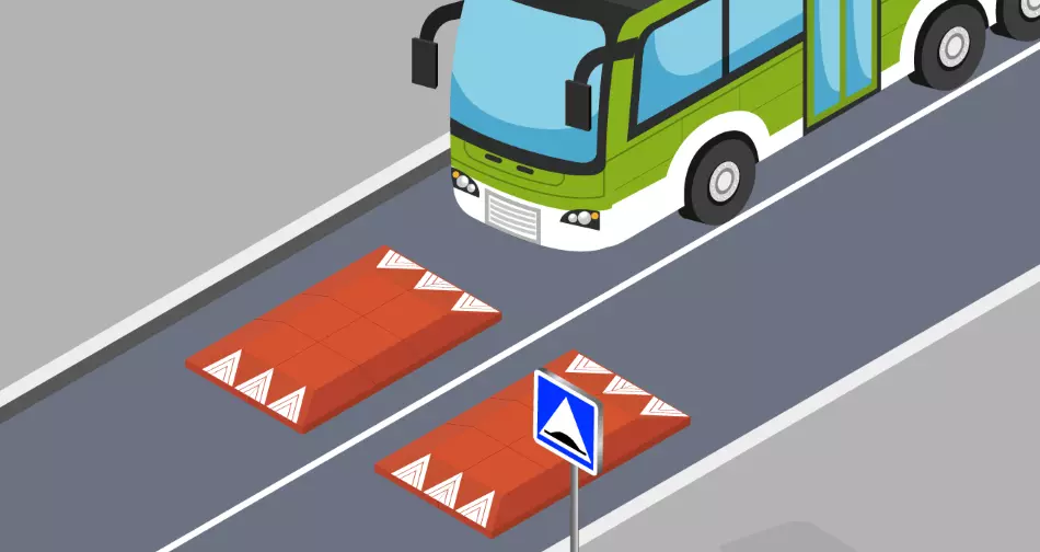 A bus is about to drive over two red Europe-style speed cushions.