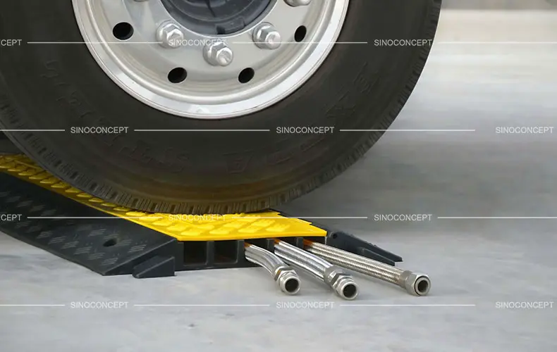 A 5-channel rubber cable ramp with yellow plastic lids used to protect wires and cables.