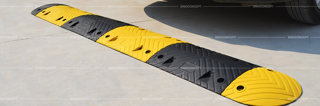 Black and white speed bump made from vulcanized rubber