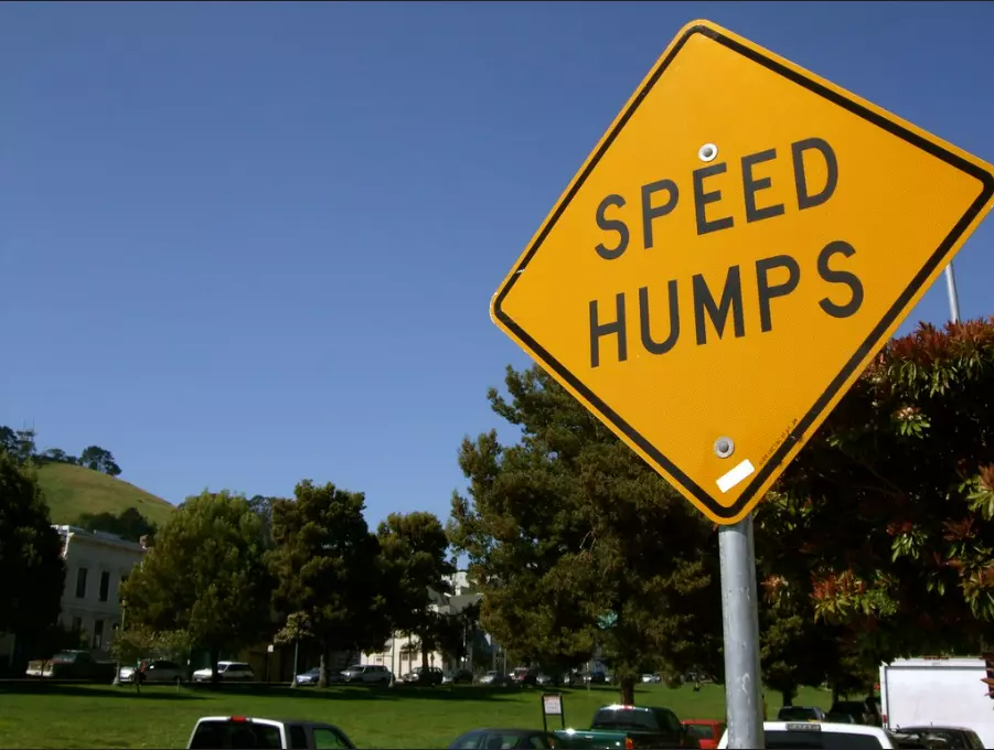 A speed hump sign warning people there are speed humps around.