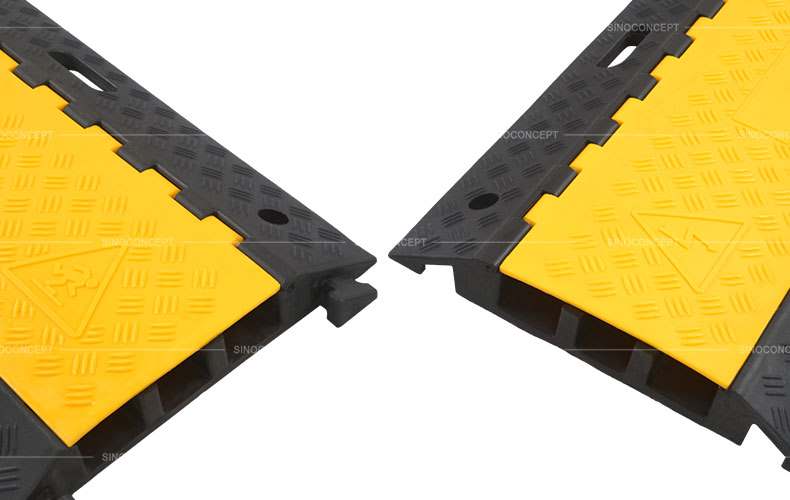 Rubber cable protector made of black vulcanized rubber and yellow plastic cover designed with a convenient interlocking system.