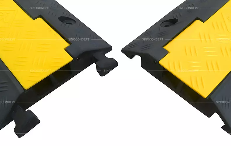 Cable cover ramps made of black rubber with yellow plastic covers are designed with an interlocking system.