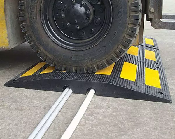 A black and yellow heavy-duty speed hump which can withstand high loads.