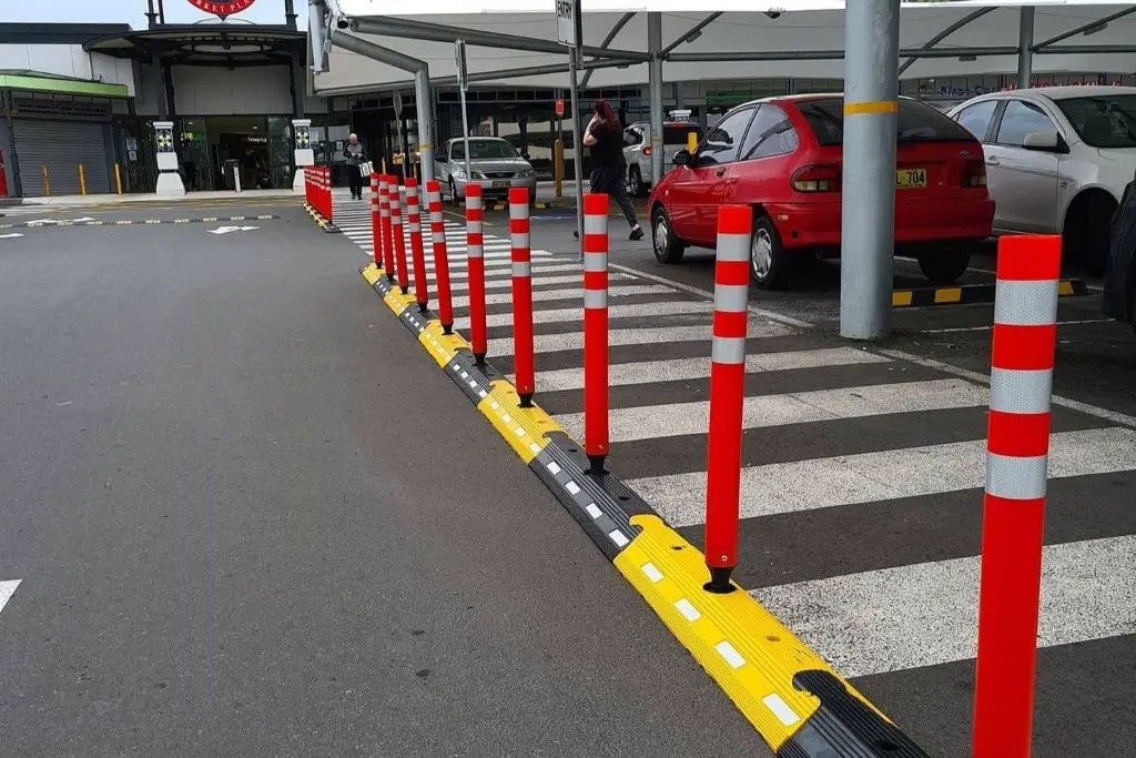 Black and yellow cycle lane dividers with red delineator posts used to separate different lanes.