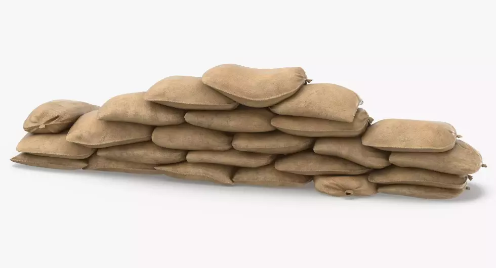 Many sandbags are stacked together to make a sandbag barricade