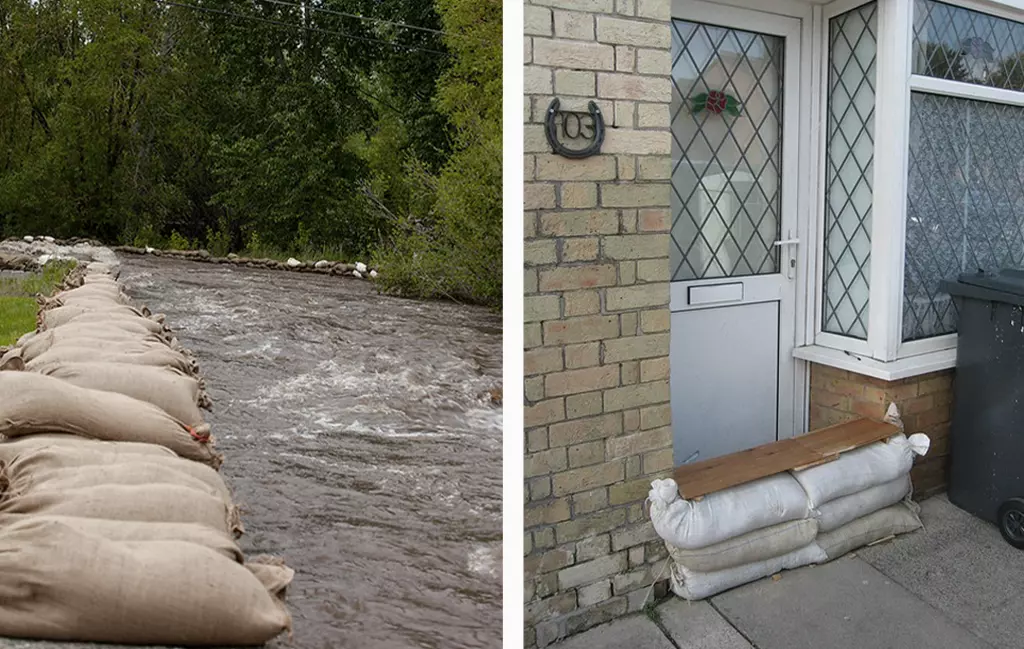 Many burlap sandbags stacked together by the river to prevent flooding, and some white sandbags are put by the door.