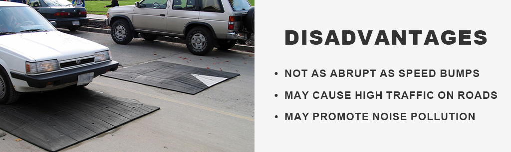 Black and white speed cushions on the road to reduce vehicles' speed.