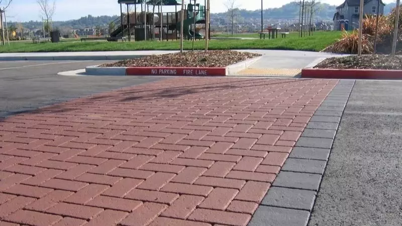 Textured pavements that alert drivers to enter pedestrian zones and lower their speed.