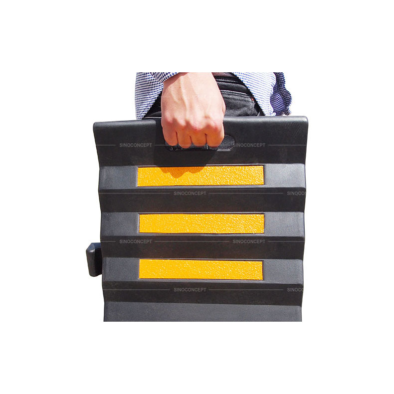 Cable hose protection ramp made of black rubber and glass bead reflective tapes with a convenient handle for easy movement