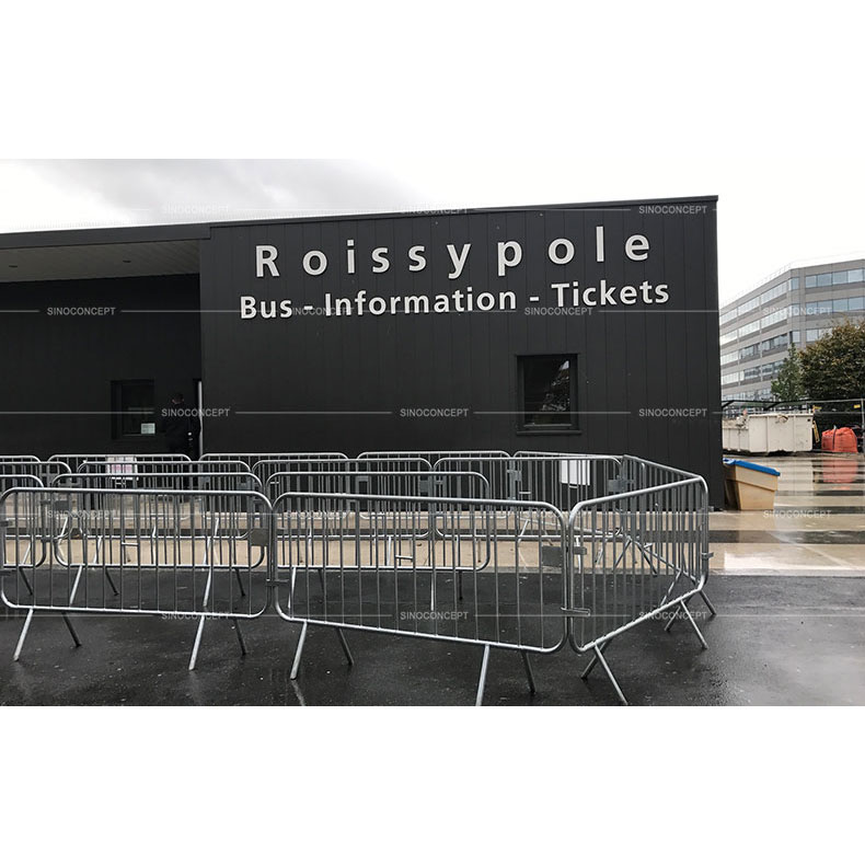 Many pedestrian safety barriers are linked together to be used for the safety of the people in the queue.