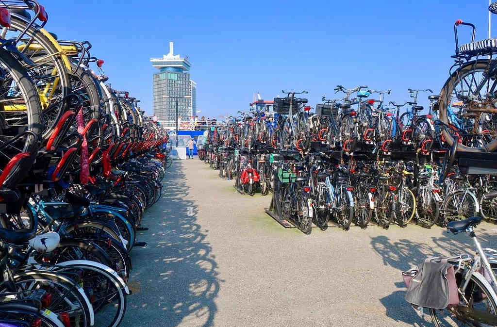 This is a bicycle parking lot with many bikes parked using double-decker racks, allowing for two levels of parking.