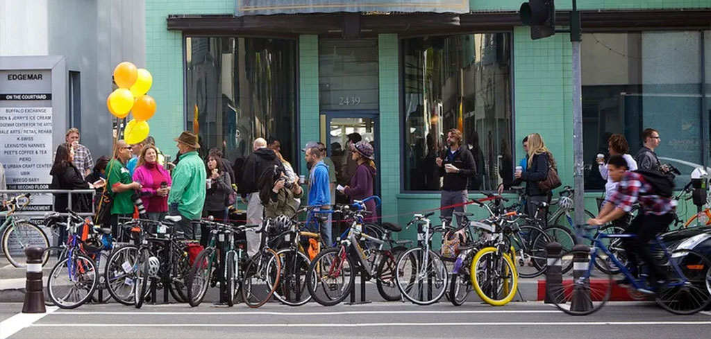 Many bicycles and pedestrians on the street.