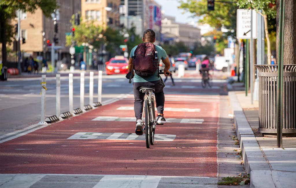 A red bike and bus lane with white markings to enhance everyone's safety.