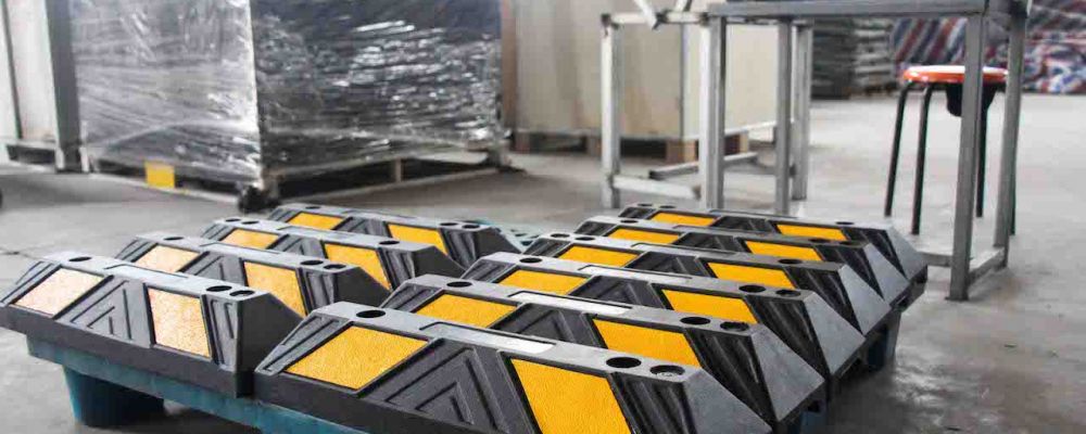 Black parking curbs are made of vulcanized rubber and pasted with yellow reflective films for car parking management