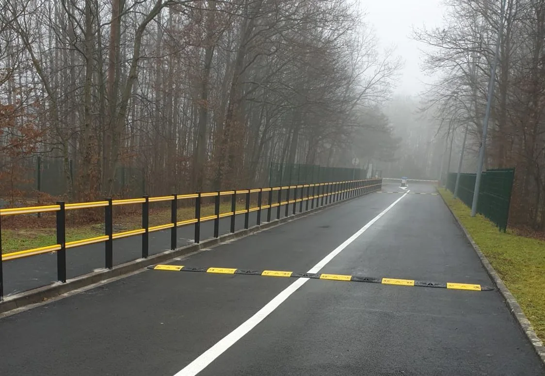 Black and yellow road bumps used to reduce speed as traffic-calming tools.