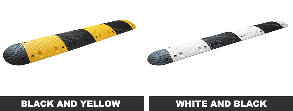A black and yellow, and a black and white speed bump used for traffic-calming purposes.