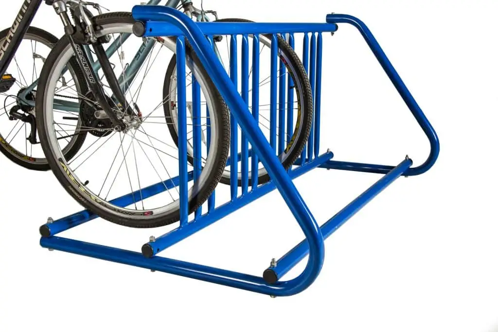 Two bicycles parked on a blue bicycle rack, which providing efficient storage for multiple bikes.