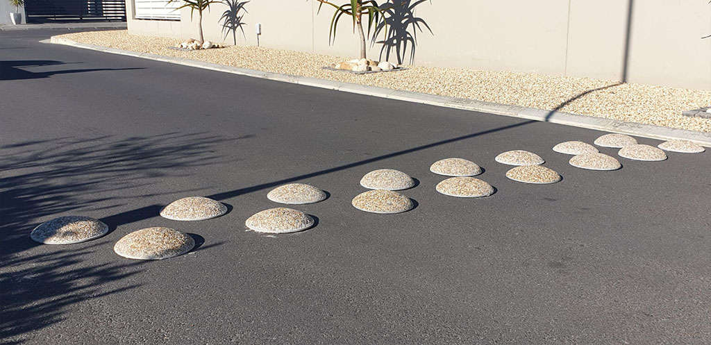 Circular speed bumps on the road to improve safety of all road users.