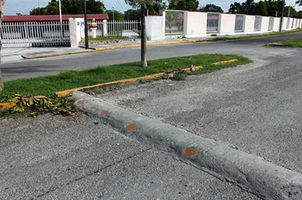 A concrete speed bump on the road to reduce speed.