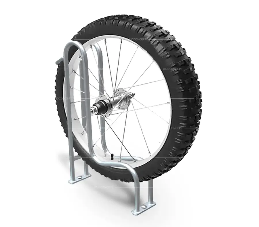 A bike wheel on a steel cycle rack.