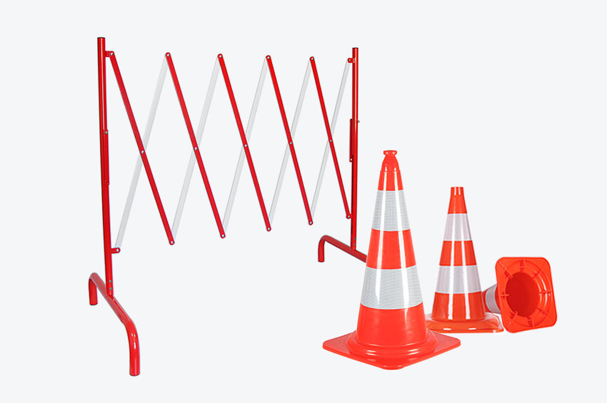 Red and white expandable steel barriers and PVC traffic cones with reflective tapes used for traffic control management