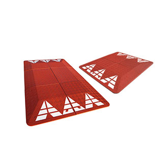 Red rubber speed cushions, also called speed tables made of red recycled rubber and white reflective tapes used for traffic calming.