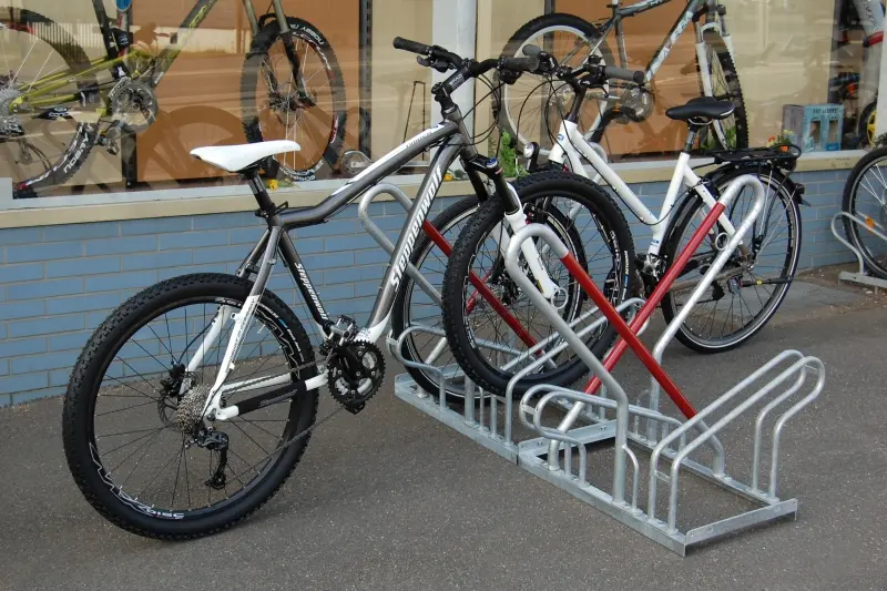 Lockable steel bike rack made with hot-dip galvanizing finishing treatment used for outdoor cycle parking.