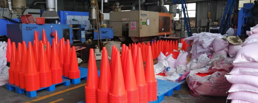 Lots of orange traffic cones made of PVC material are manufactured in Sino Concept's plastic factory.