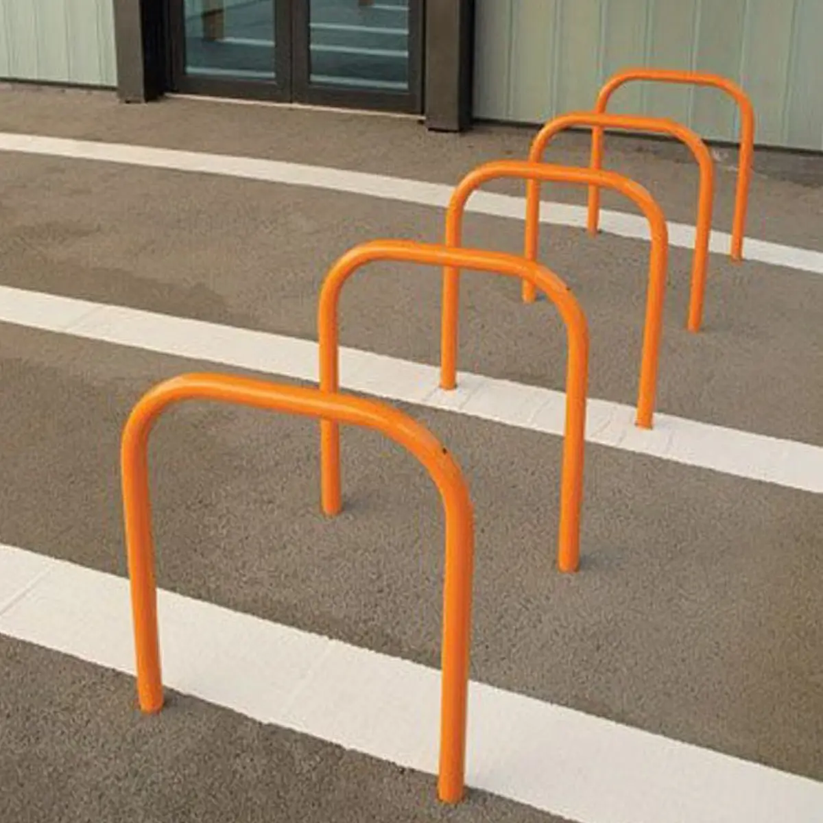 Orange Sheffield cycle stands used for bike parking.