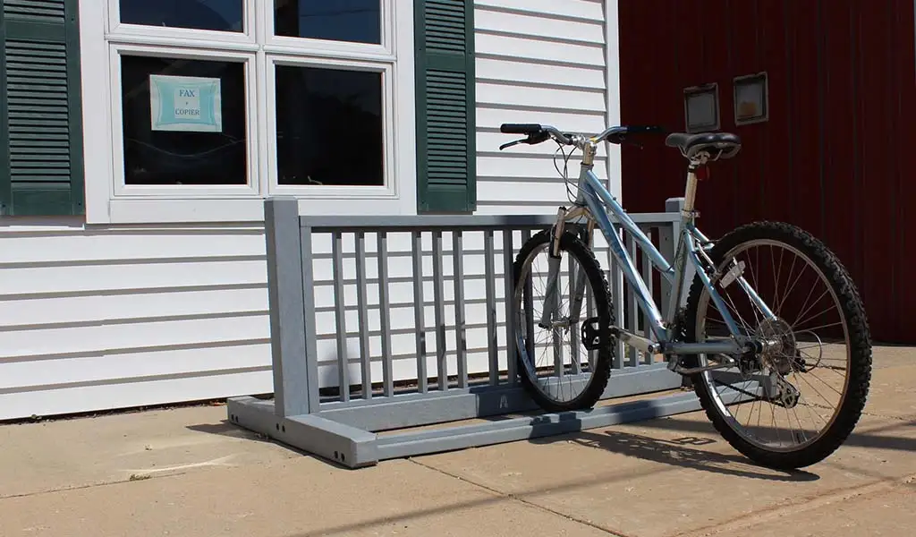 Gray floor mounted bike stands made of recycled plastic for bike parking.