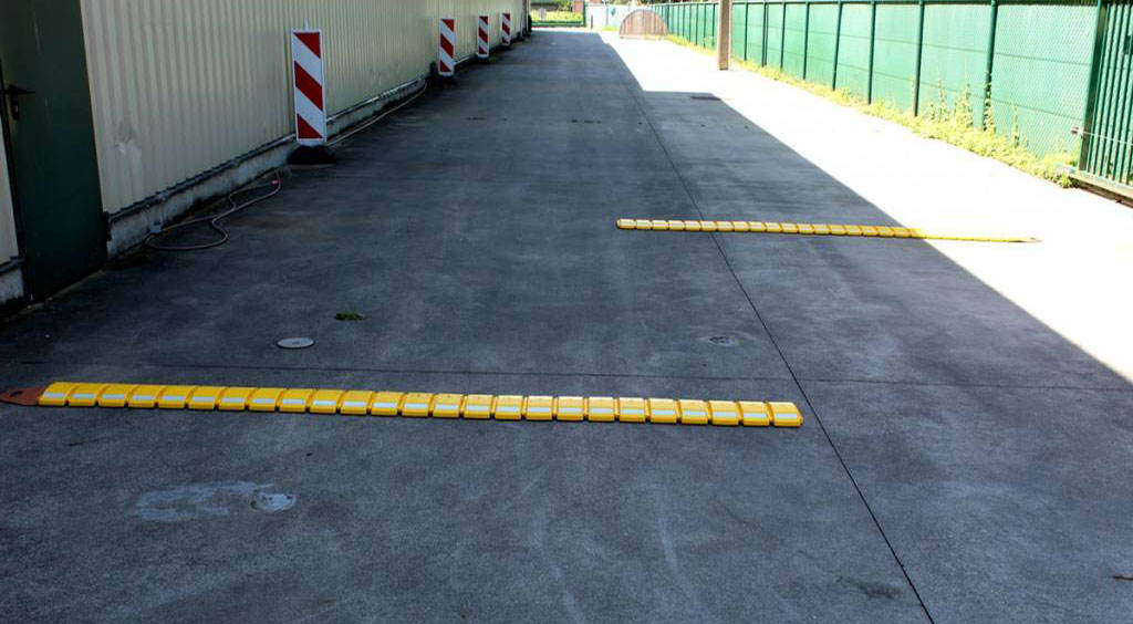 Yellow portable speed bumps on the road as a temporary traffic-calming measure.