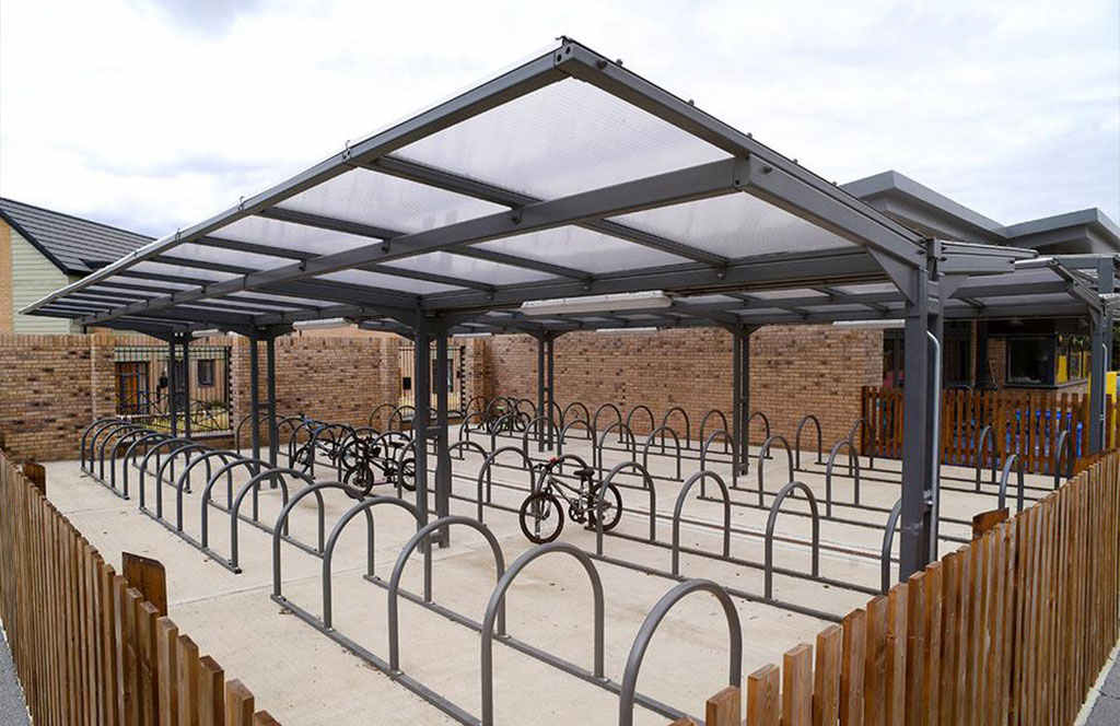 Rail-style cycle racks mounted on the ground for cycle parking, which are more space-efficient.