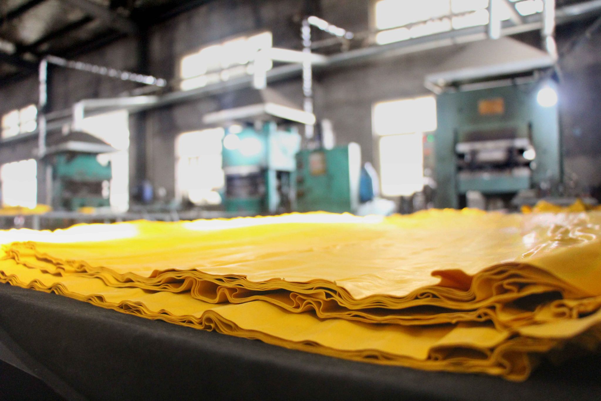Yellow recycled rubber material ready to be used to produce traffic safety products like speed bump in Sino Concept's rubber factory.