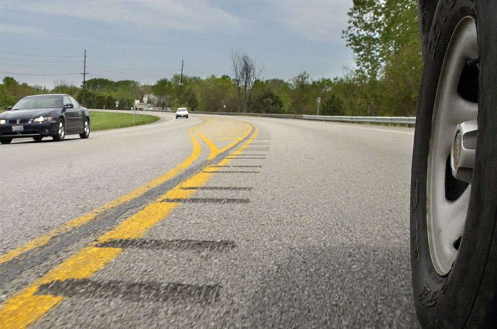 Rumble strips in the middle of the road to alert drivers when they move from their traffic lane.