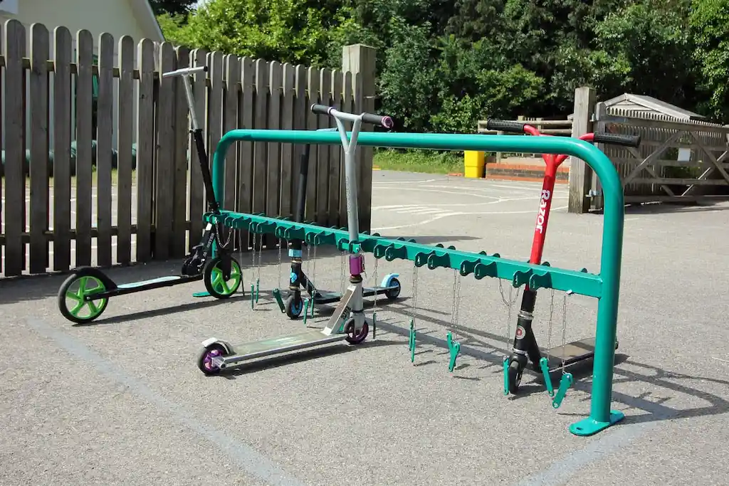 A green scooter rack used to place scooters.