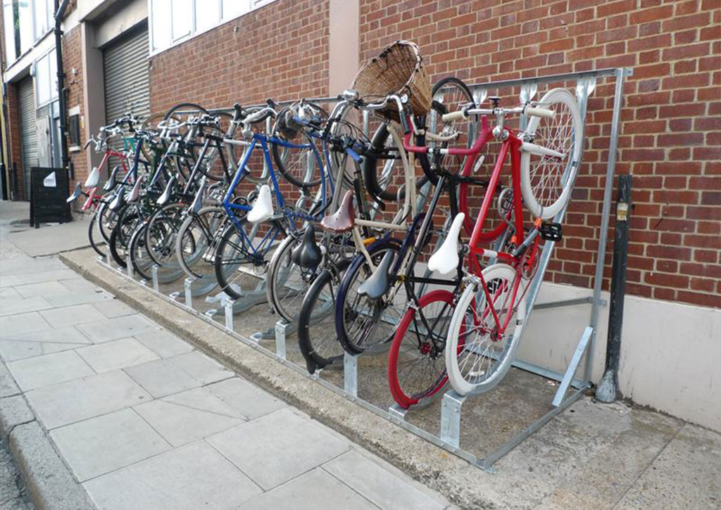 Semi-vertical bike racks installed against the wall to store bicycles without taking up a lot of room.