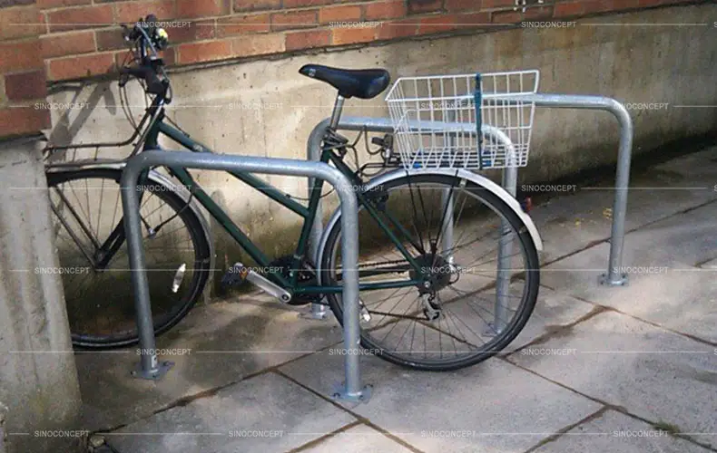 A bicycle parked securely on Sheffield-style bicycle racks.