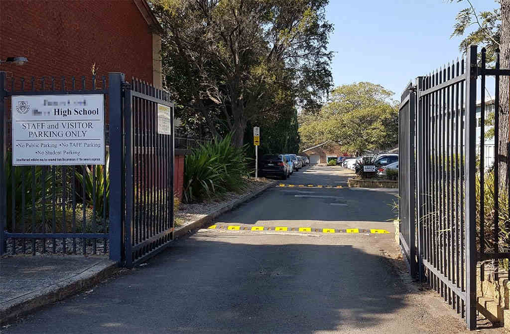 Black and yellow speed bumps installed in the high school campus.